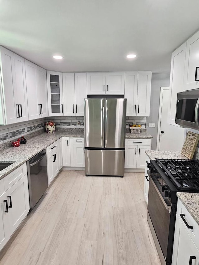 233 Inlet Shores Dr, Delavan, WI 53115 - kitchen with appliances with stainless steel finishes, tasteful backsplash, white cabinetry, and recessed lighting