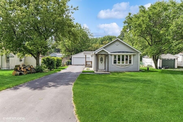 2605 Cameron St, Delavan, WI 53115 - view of front of home with a detached garage and a front lawn