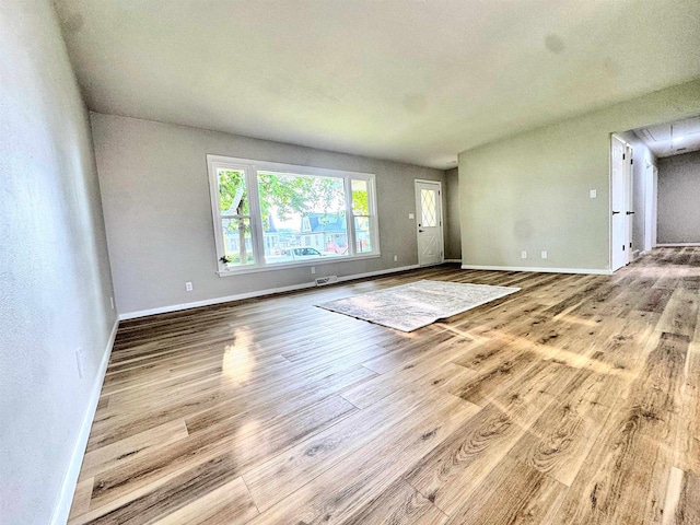 722 Michigan Ave, North Fond Du Lac, WI 54937 - unfurnished living room with wood finished floors and baseboards