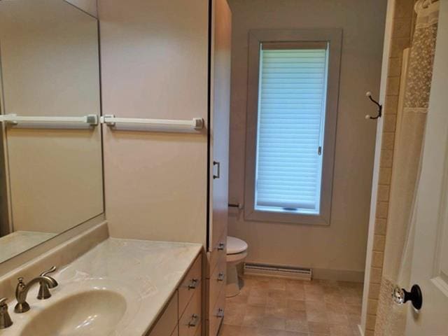 9350 County Road F, Milladore, WI 54454 - bathroom with toilet, baseboards, vanity, a baseboard radiator, and a shower
