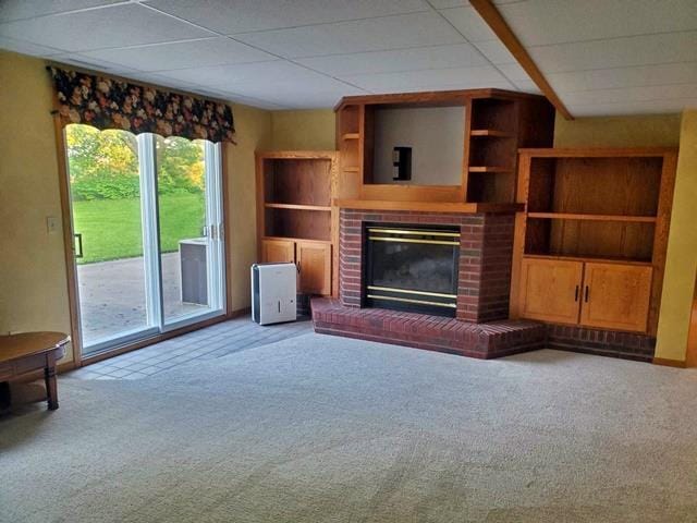 9350 County Road F, Milladore, WI 54454 - unfurnished living room featuring carpet flooring, a fireplace, and a paneled ceiling