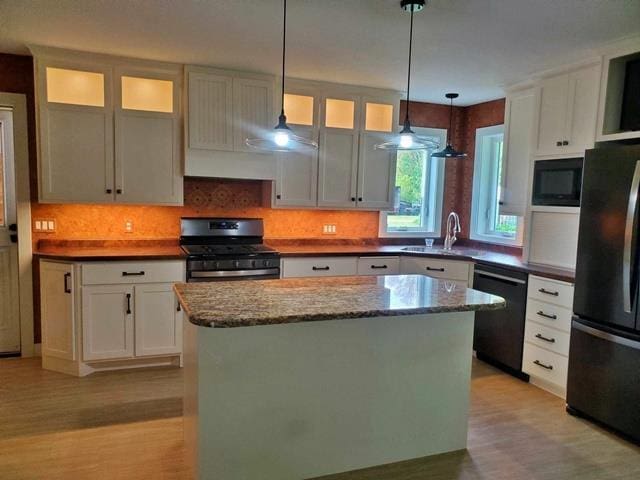 9350 County Road F, Milladore, WI 54454 - kitchen featuring black appliances, a sink, light wood-style flooring, and a center island