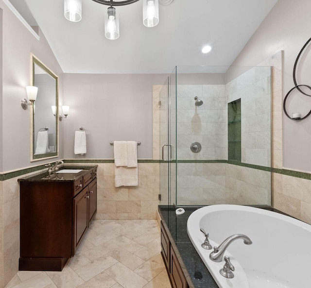 102 Abbey Ridge Ct Unit 102, Fontana, WI 53125 - bathroom featuring tile walls, a shower stall, vanity, a garden tub, and lofted ceiling