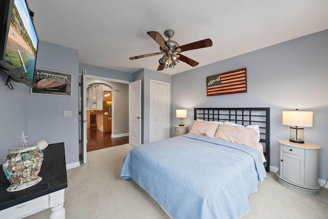 102 Abbey Ridge Ct Unit 102, Fontana, WI 53125 - bedroom with light carpet, arched walkways, baseboards, and a closet
