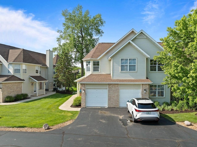 102 Abbey Ridge Ct Unit 102, Fontana, WI 53125 - view of front of house featuring asphalt driveway, a front yard, a garage, a shingled roof, and brick siding