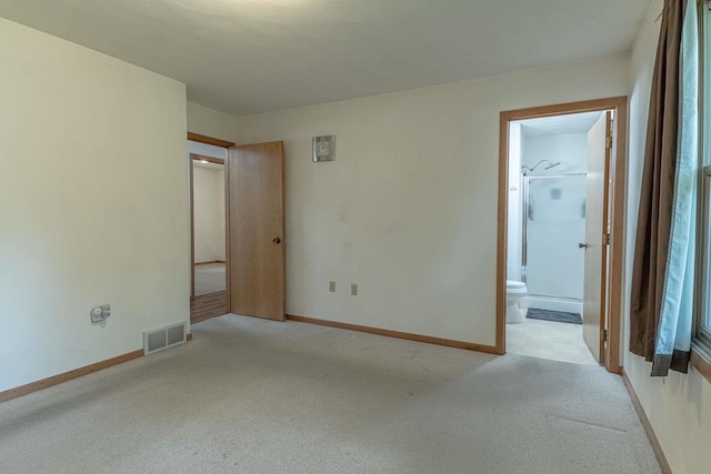 119 N 12th Ave, Monroe, WI 53566 - unfurnished bedroom with light colored carpet and ensuite bath
