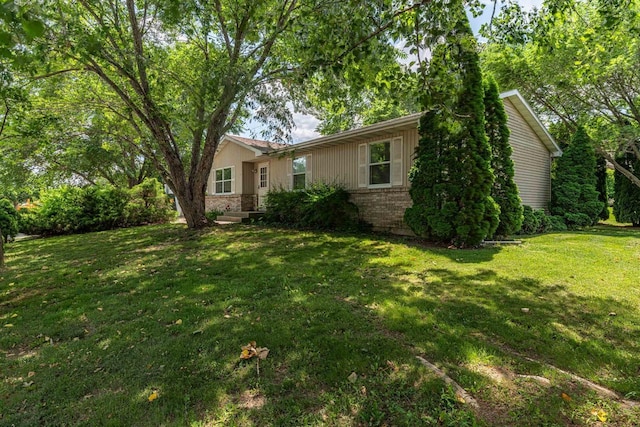 119 N 12th Ave, Monroe, WI 53566 - view of front of house featuring brick siding and a front lawn
