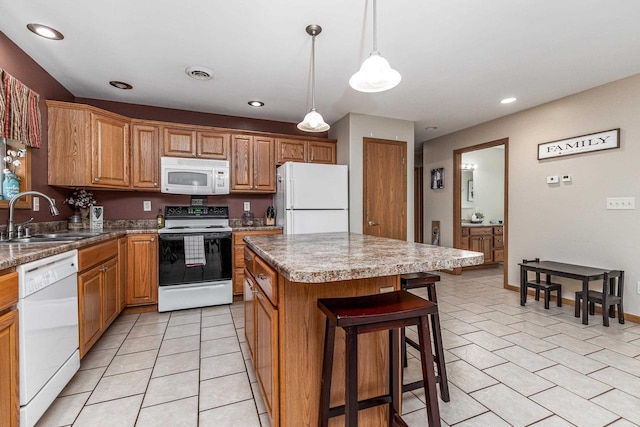 1390 21st St, Hazel Green, WI 53811 - kitchen featuring white appliances, a sink, a center island, a breakfast bar, and recessed lighting