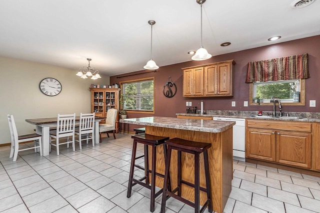 1390 21st St, Hazel Green, WI 53811 - kitchen with a sink, dishwasher, light tile patterned floors, a kitchen island, and decorative light fixtures