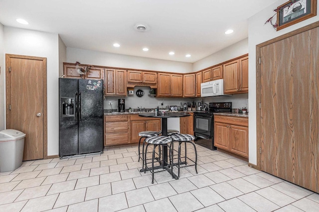1390 21st St, Hazel Green, WI 53811 - kitchen featuring black appliances, recessed lighting, and brown cabinetry