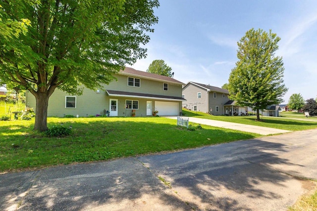 1390 21st St, Hazel Green, WI 53811 - traditional-style house with an attached garage, driveway, a front lawn, and a residential view