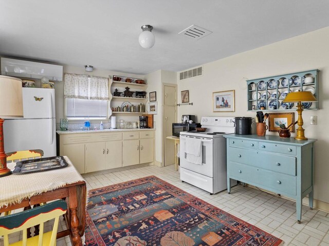 8090 State Highway 57, Baileys Harbor, WI 54202 - kitchen featuring white appliances, light countertops, open shelves, and brick patterned floors