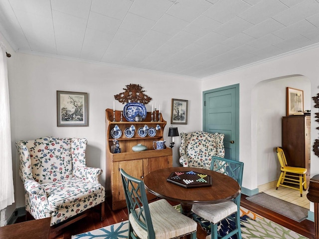 8090 State Highway 57, Baileys Harbor, WI 54202 - dining room featuring wood finished floors, ornamental molding, and arched walkways