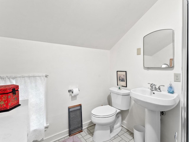 8090 State Highway 57, Baileys Harbor, WI 54202 - half bathroom featuring lofted ceiling, toilet, and baseboards