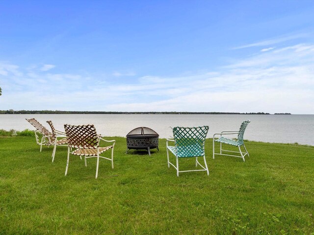 8090 State Highway 57, Baileys Harbor, WI 54202 - view of grassy yard with an outdoor fire pit and a water view