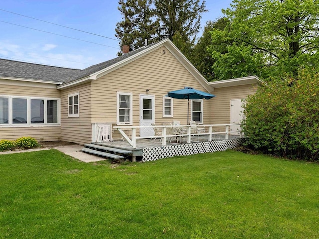 8090 State Highway 57, Baileys Harbor, WI 54202 - back of property featuring a yard, a deck, a chimney, and roof with shingles