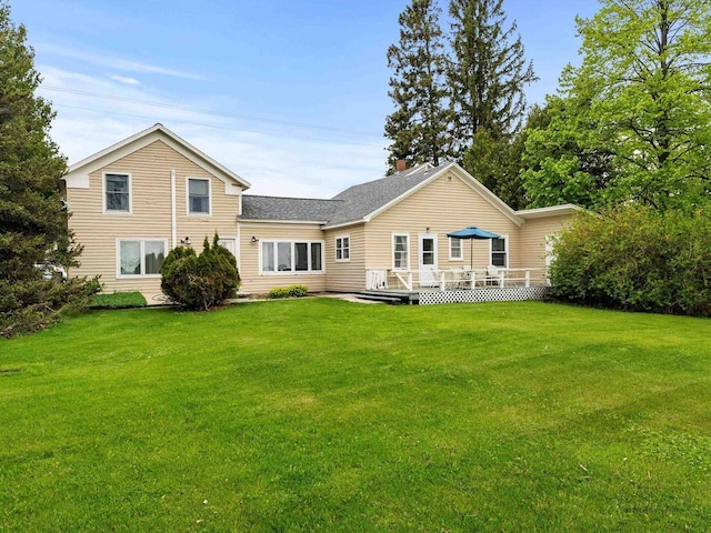 8090 State Highway 57, Baileys Harbor, WI 54202 - back of property featuring a wooden deck, a lawn, a chimney, and a shingled roof