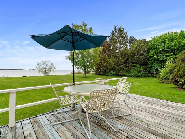 8090 State Highway 57, Baileys Harbor, WI 54202 - deck featuring outdoor dining area, a water view, and a yard