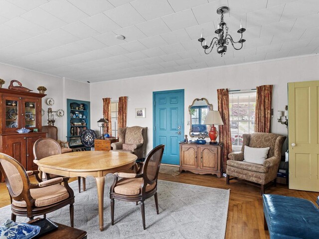 8090 State Highway 57, Baileys Harbor, WI 54202 - dining space with a chandelier, ornamental molding, and wood finished floors