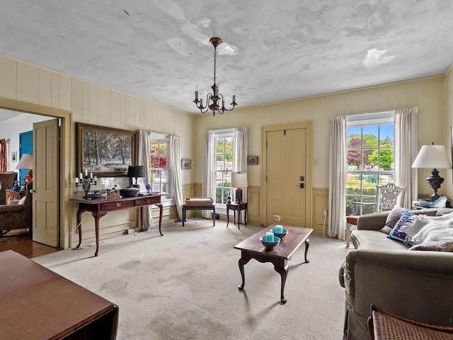 8090 State Highway 57, Baileys Harbor, WI 54202 - living area featuring a chandelier, a textured ceiling, carpet, and wood walls