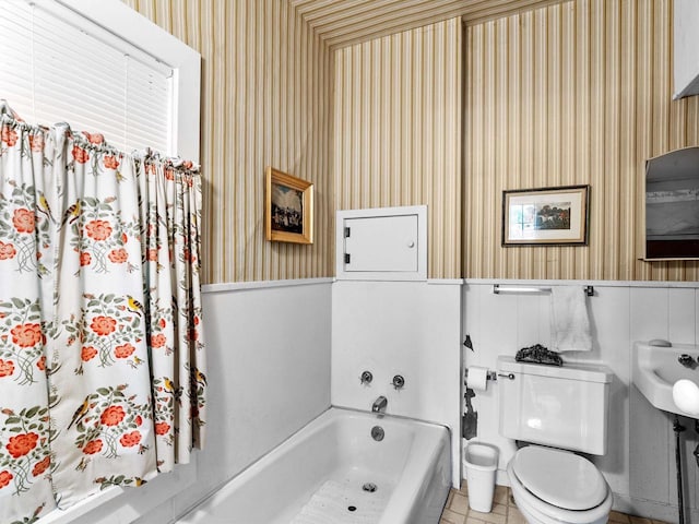 8090 State Highway 57, Baileys Harbor, WI 54202 - full bath featuring wallpapered walls, a tub to relax in, toilet, wainscoting, and a sink
