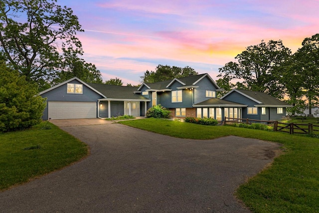 4080 Windermere Ln, Oshkosh, WI 54902 - tri-level home with driveway, an attached garage, and brick siding
