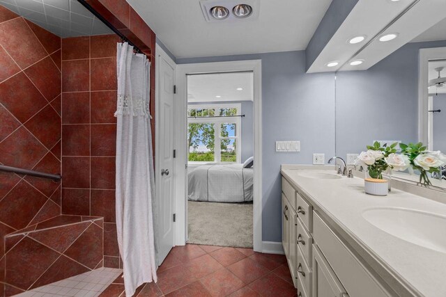 4080 Windermere Ln, Oshkosh, WI 54902 - bathroom featuring recessed lighting, double vanity, tiled shower, tile patterned flooring, and connected bathroom
