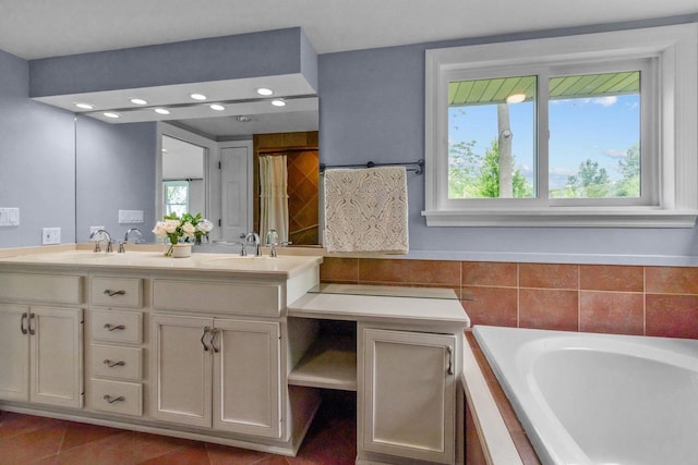 4080 Windermere Ln, Oshkosh, WI 54902 - bathroom featuring double vanity, tiled bath, healthy amount of natural light, and tile patterned flooring