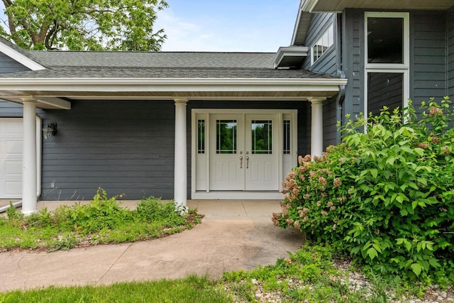 4080 Windermere Ln, Oshkosh, WI 54902 - view of exterior entry with a shingled roof, a porch, and french doors