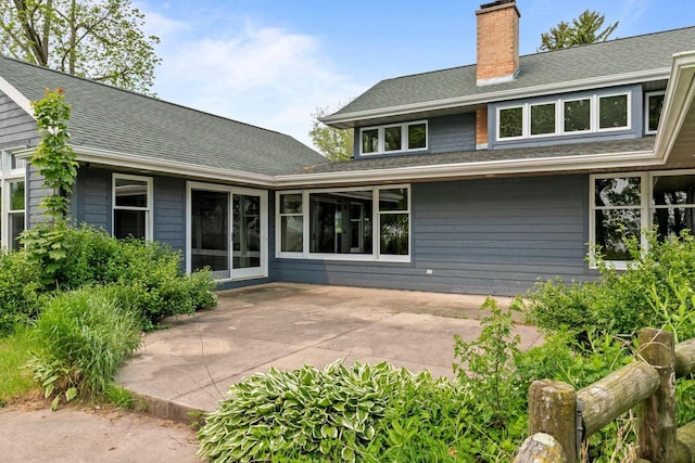 4080 Windermere Ln, Oshkosh, WI 54902 - back of property featuring a chimney, a patio area, and a shingled roof