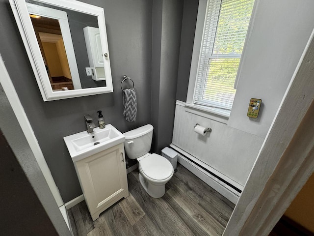 432 W Capitol Dr, Hartland, WI 53029 - bathroom featuring baseboard heating, wood finished floors, toilet, and vanity