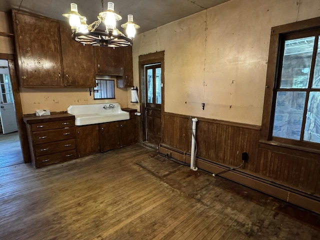 432 W Capitol Dr, Hartland, WI 53029 - kitchen featuring a chandelier, dark wood-style flooring, a wainscoted wall, a sink, and a baseboard radiator