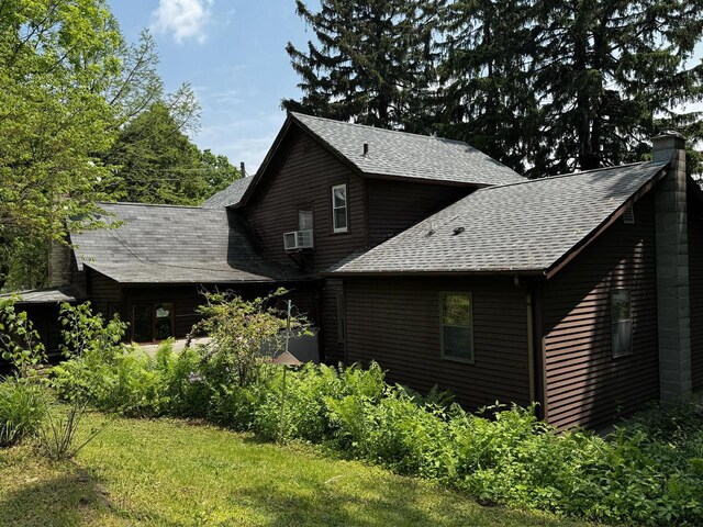 432 W Capitol Dr, Hartland, WI 53029 - back of property with a shingled roof and a chimney
