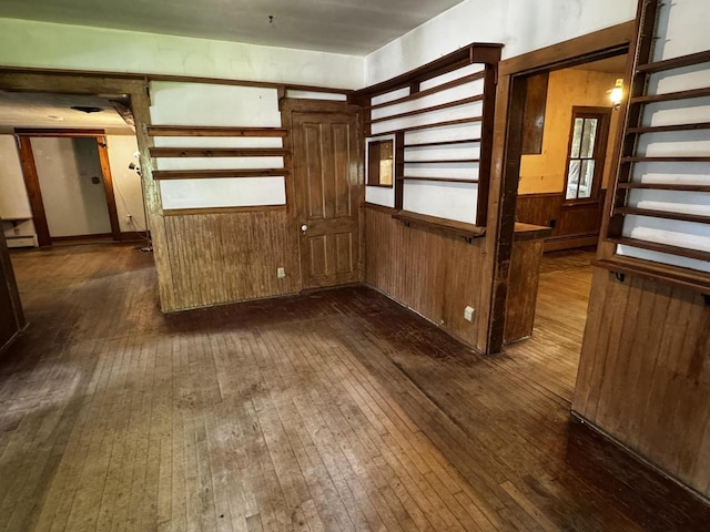 432 W Capitol Dr, Hartland, WI 53029 - spare room with dark wood-type flooring, a baseboard heating unit, and wood walls