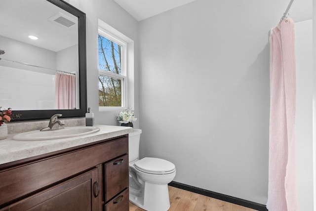 831 Setter Dr, Kaukauna, WI 54130 - bathroom with toilet, vanity, wood finished floors, a shower with curtain, and baseboards