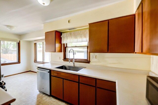 1516 Pierce Ave, Oshkosh, WI 54902 - kitchen with stainless steel appliances, a sink, light countertops, light flooring, and baseboards