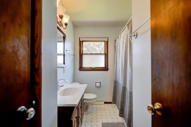 1516 Pierce Ave, Oshkosh, WI 54902 - full bath with toilet, vanity, a baseboard heating unit, tile patterned floors, and curtained shower