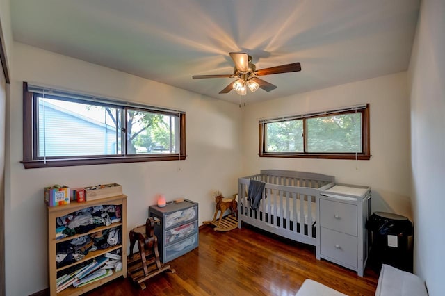 1516 Pierce Ave, Oshkosh, WI 54902 - bedroom featuring wood finished floors, a crib, and ceiling fan