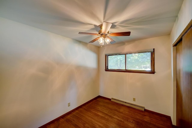1516 Pierce Ave, Oshkosh, WI 54902 - unfurnished bedroom featuring baseboard heating, a closet, dark wood-style flooring, and a ceiling fan