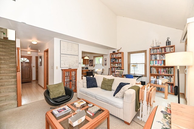 2016 Madera St Unit 2018, Waukesha, WI 53189 - living area featuring light colored carpet, stairs, and high vaulted ceiling