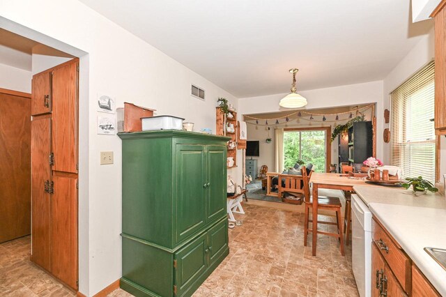 2016 Madera St Unit 2018, Waukesha, WI 53189 - kitchen with green cabinets, stone finish floors, white dishwasher, and light countertops