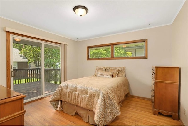 1711 Olive St, Stillwater, MN 55082 - bedroom with crown molding, access to exterior, light wood-style flooring, and baseboards