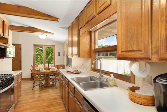 1711 Olive St, Stillwater, MN 55082 - kitchen featuring a sink, appliances with stainless steel finishes, brown cabinetry, and light wood finished floors