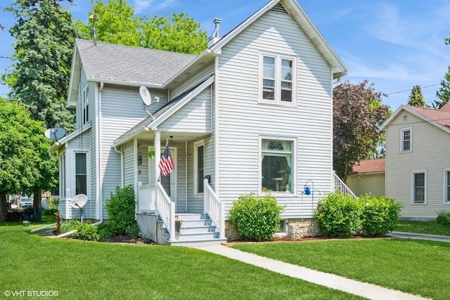 314 E Maple Ave, Beaver Dam, WI 53916 - traditional-style house with a front yard and covered porch