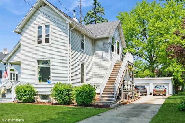 314 E Maple Ave, Beaver Dam, WI 53916 - view of front facade featuring stairs, an outdoor structure, a front lawn, and a detached garage