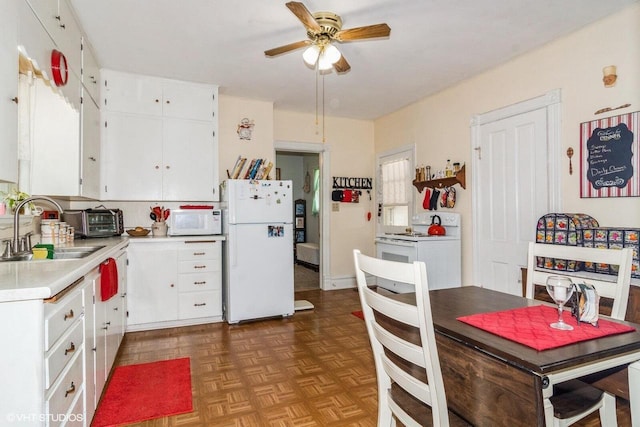 314 E Maple Ave, Beaver Dam, WI 53916 - kitchen with white appliances, a sink, a ceiling fan, light countertops, and white cabinets