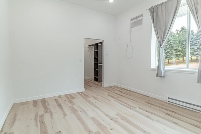 W6579 Karric Ln, Monroe, WI 53566 - spare room with light wood-style floors, ornamental molding, and a baseboard radiator