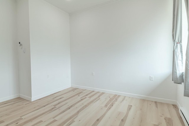 W6579 Karric Ln, Monroe, WI 53566 - empty room featuring light wood-style floors and a baseboard heating unit