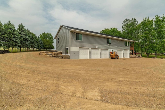 W6579 Karric Ln, Monroe, WI 53566 - view of property exterior with dirt driveway and a garage