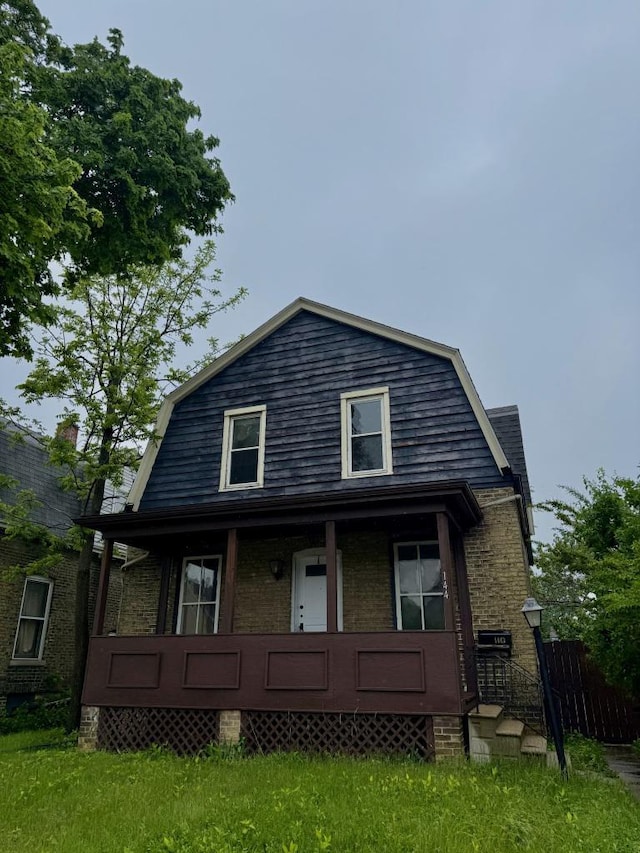 1443 Summit Ave, Racine, WI 53404 - view of front of property featuring a gambrel roof, covered porch, and brick siding